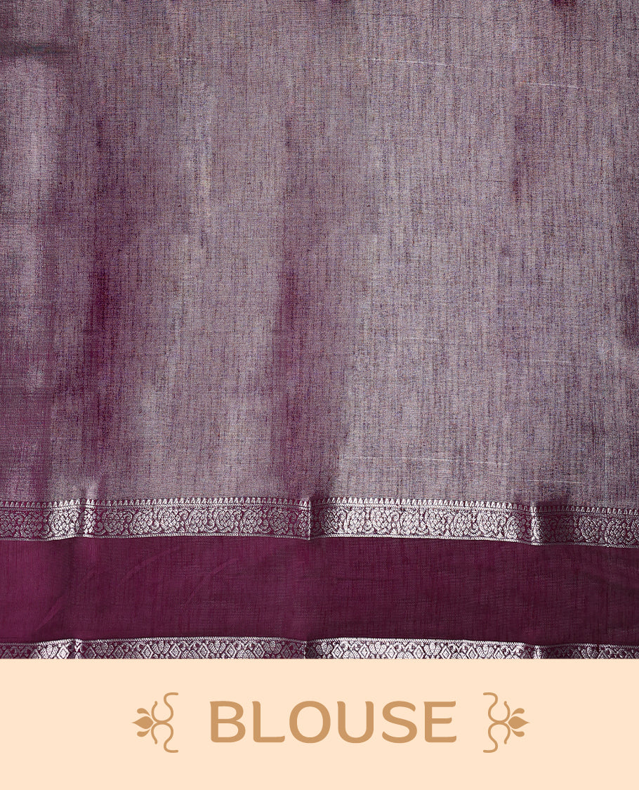 Golden yellow saree with a rich maroon border and pallu, accentuated by delicate silver zari detailing and tassel finish & The fabric has a lustrous sheen and comes with a matching blouse piece.