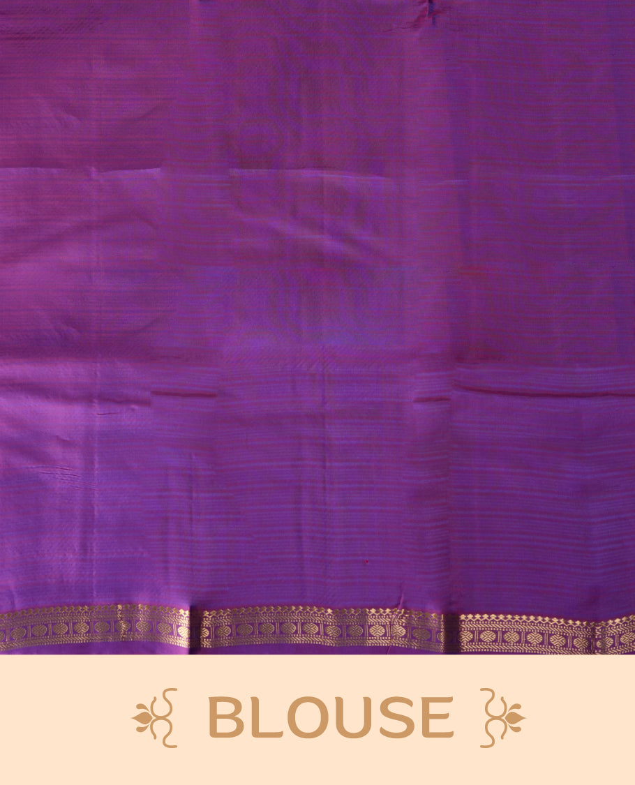 Blue colour soft silk saree adorned with delicate zari buttas, complemented by a rich contrast purple border with intricate golden zari work & Paired with a matching blouse.