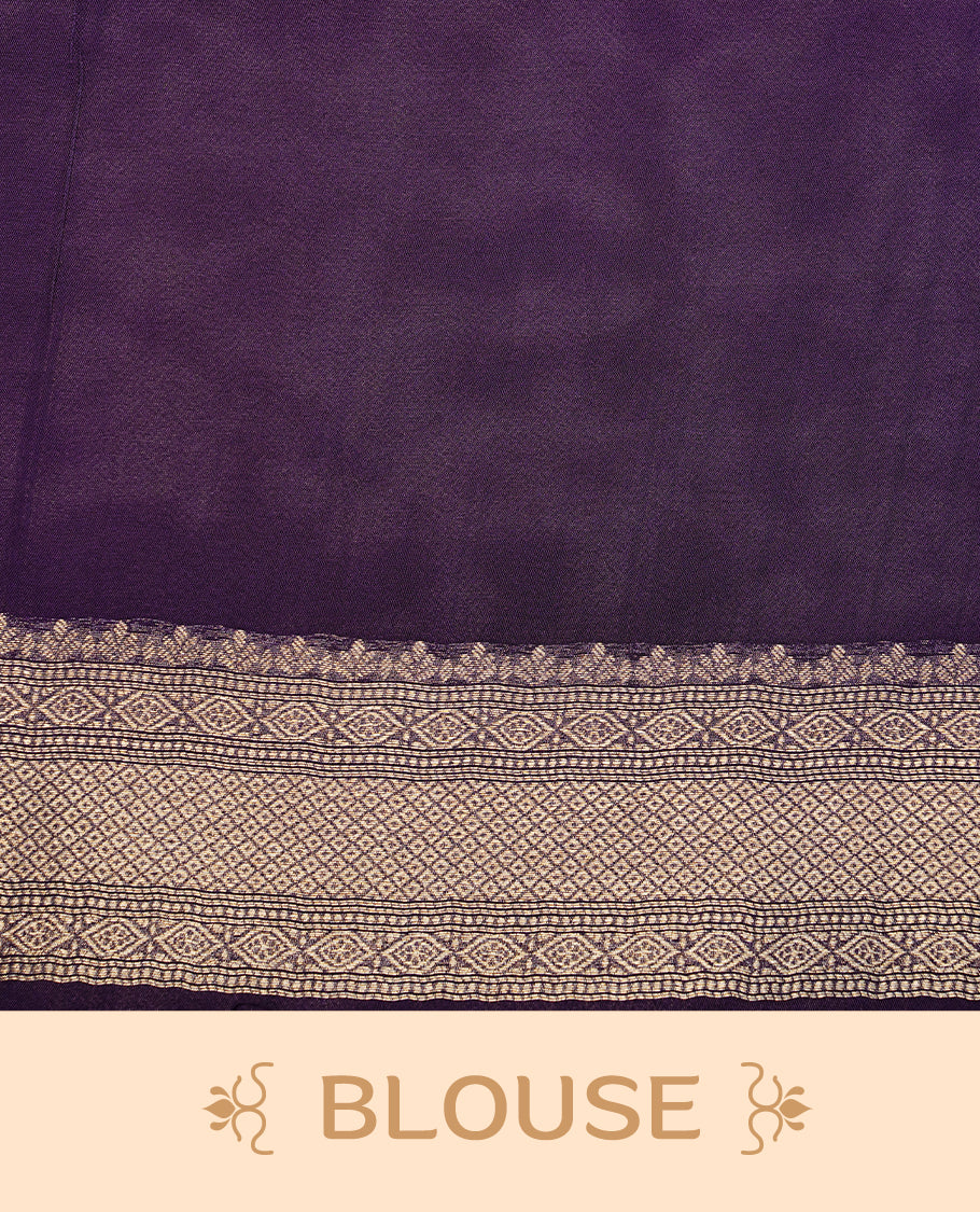 Purple colour semi Banaras crepe silk saree featuring an elegant gold zari patterned body, highlighted by a plain border adorned with traditional gold zari cow motifs. Paired with a matching blouse piece.
