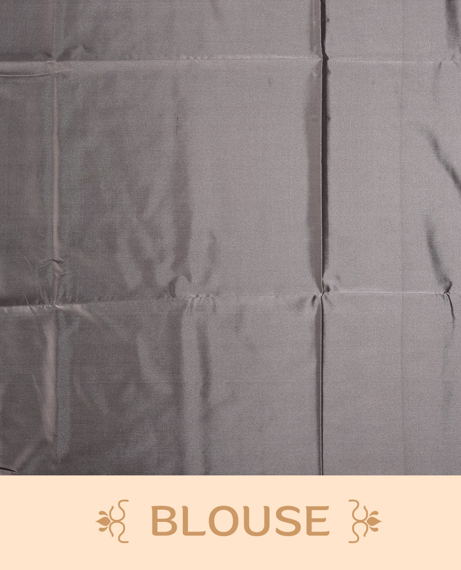 Grey colour semi soft silk saree featuring intricate woven floral motifs on the body, complemented by a rich woven border and pallu with tassel finish & Comes with a matching blouse piece for an elegant look.
