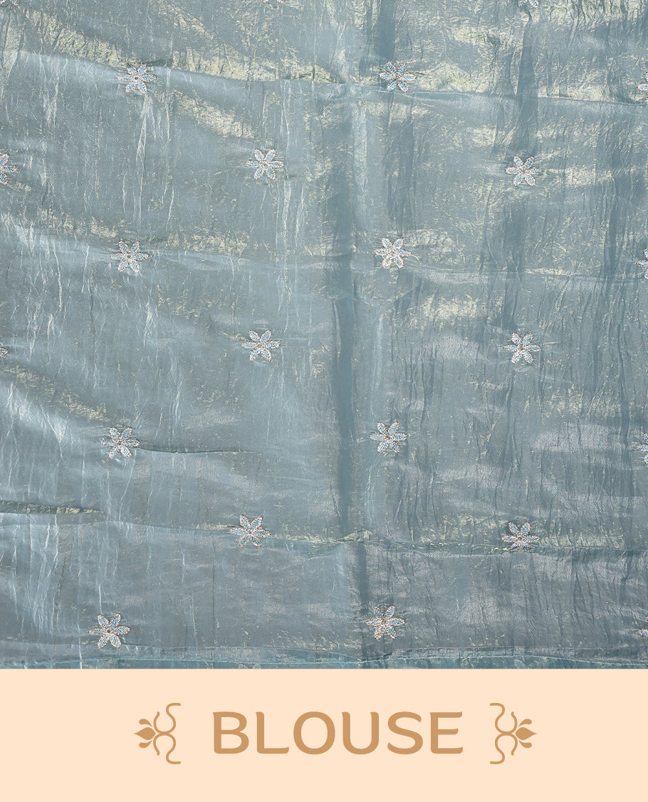 Pastel Blue colour crush soft silk saree adorned with bold floral thread embroidery on the body and scallop edged borders, Paired with a matching blouse for a complete look.