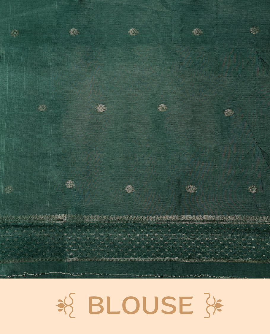 Golden saree featuring subtle self striped woven patterns on the body, enhanced with a green geometric border, complemented by a rich zari pallu with tassels, and paired with a matching blouse for a traditional elegant look.