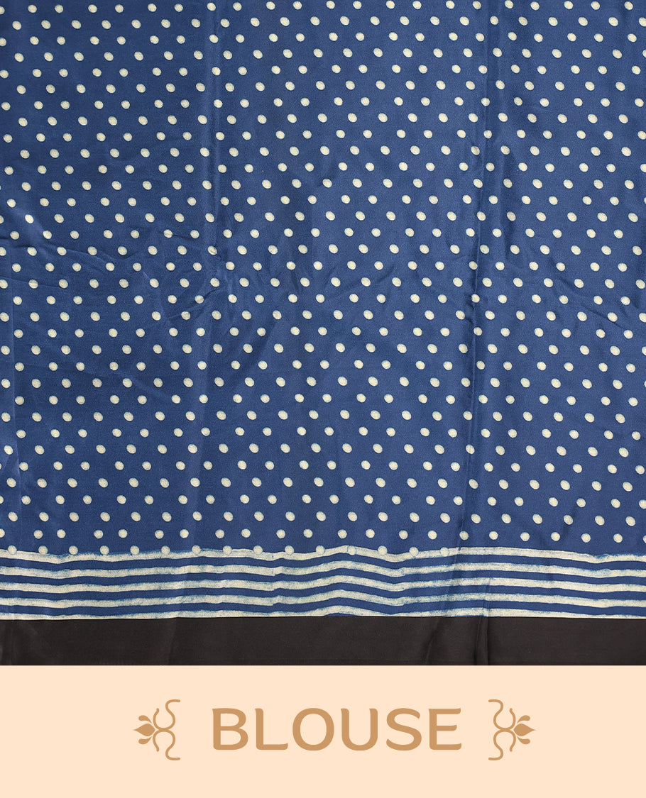 Blue colour saree featuring fine striped patterns across the body, accentuated with bold triangular designs along the border, and a contemporary pallu with geometric detailing, paired with a matching blouse.