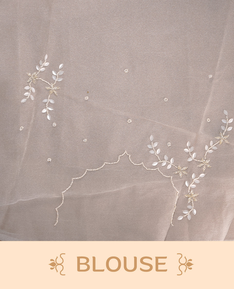 White colour crush organza saree featuring white floral work with beats & sequins, highlighting scalp with beats worked border, paired with matching blouse piece.
