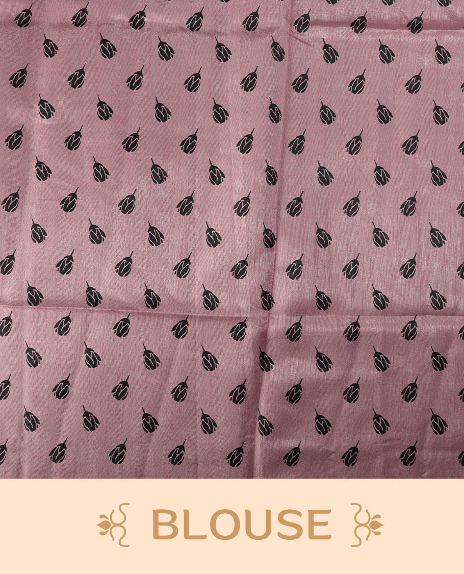 Pastel pink colour saree with black floral prints all over the body, complemented by a contrasting black pallu adorned with bold floral designs and striped detailing & Paired with a matching blouse for a complete look.
