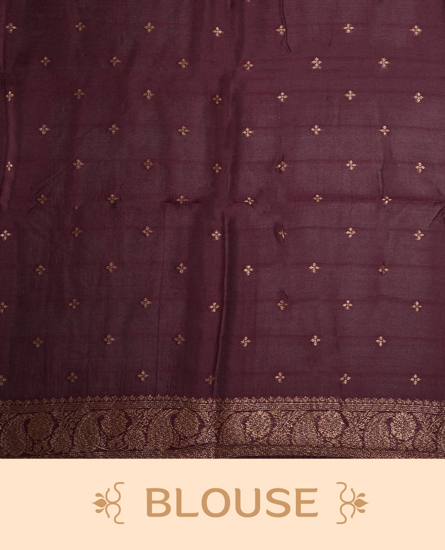Dark maroon colour semi Banarasi Tussar Georgette saree with gold zari motifs on the body, a grand woven golden pallu, and ornate zari border. Includes a matching blouse piece for a complete look.