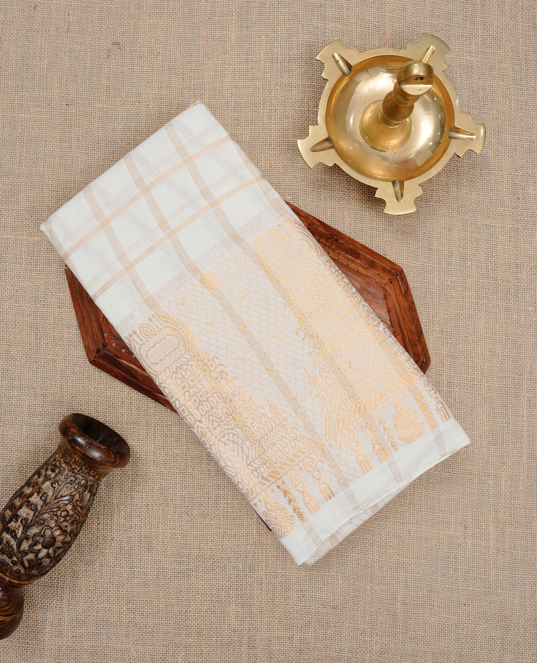 Off white colour Sungudi cotton saree featuring Gold zari checks on body, Gold zari temple design on Self colour border, paired with matching blouse piece.