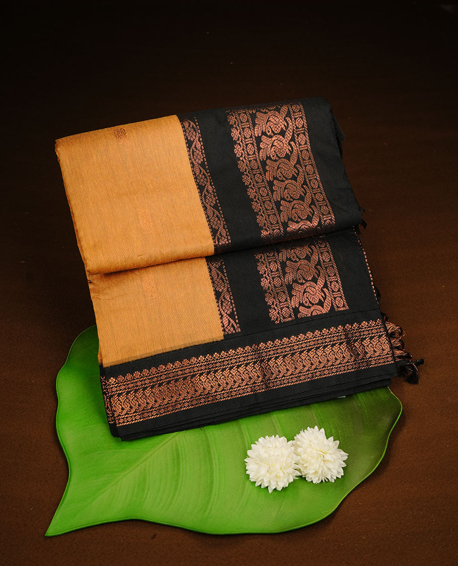 Mustard colour kalyani cotton saree featuring Elegant plain body, complemented by Black colour with Antique zari border, paired with matching blouse piece.