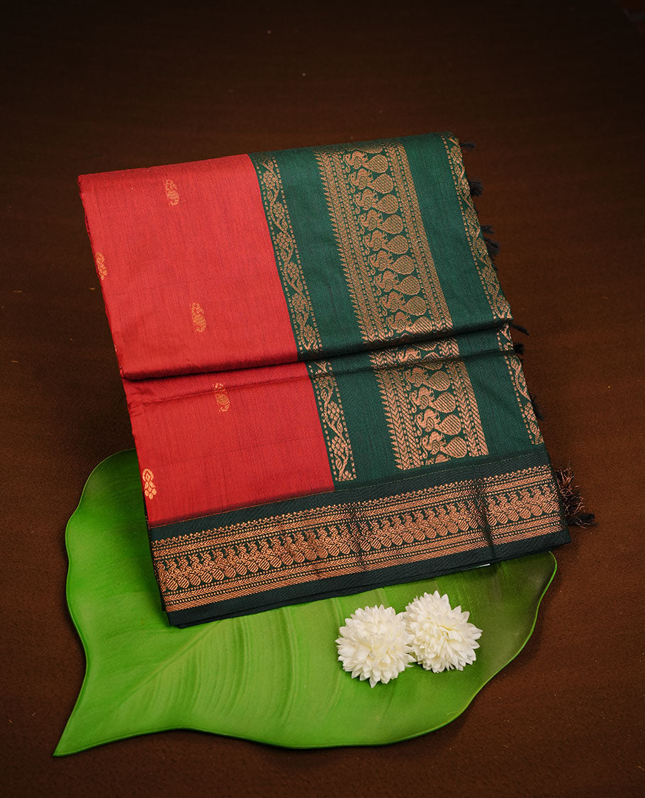 Red colour kalyani cotton saree featuring antique zari motifs on body, complemented by Green colour with Antique zari border, paired with matching blouse piece.