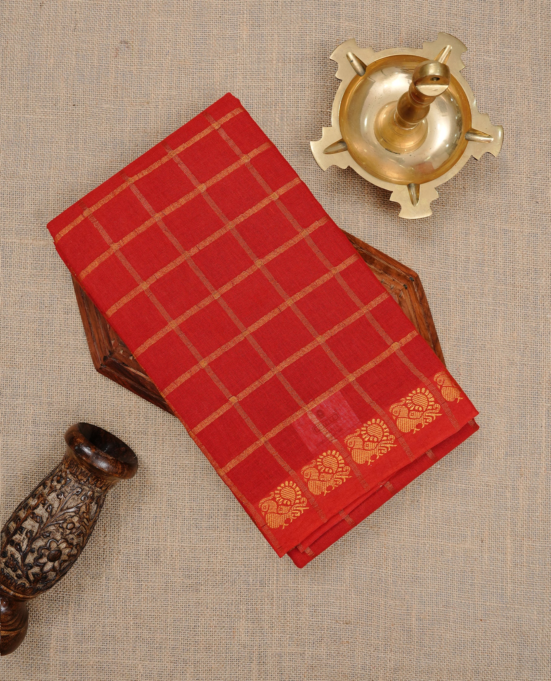 Red colour Sungudi cotton saree featuring Gold zari Check pattern on body, Gold zari Peacock design on Self colour border, paired with matching blouse piece.