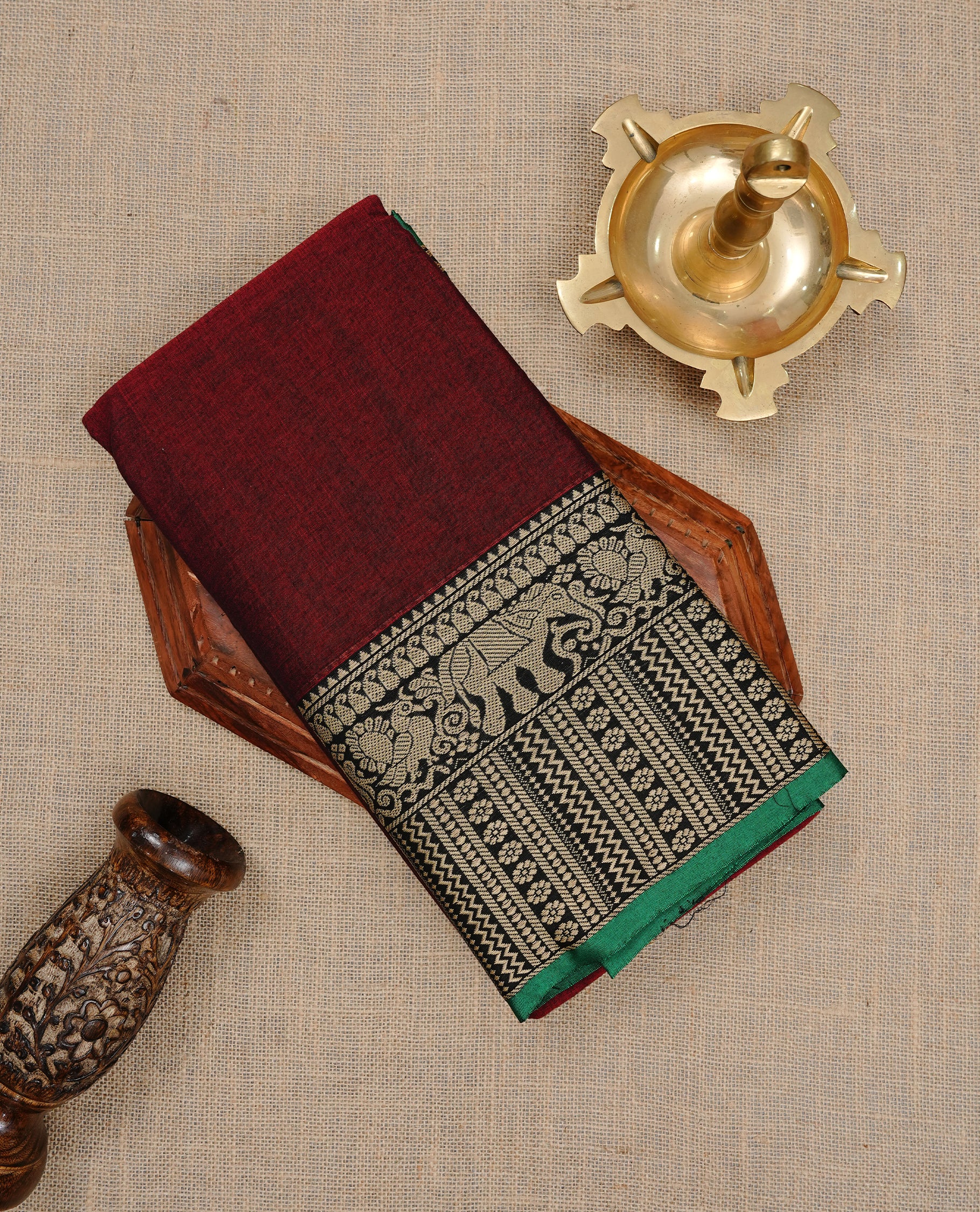 Maroon colour Narayanapett cotton saree Featuring Elegant plain Body, complemented by Contrast Black colour with cream zari border, paired with matching blouse piece.