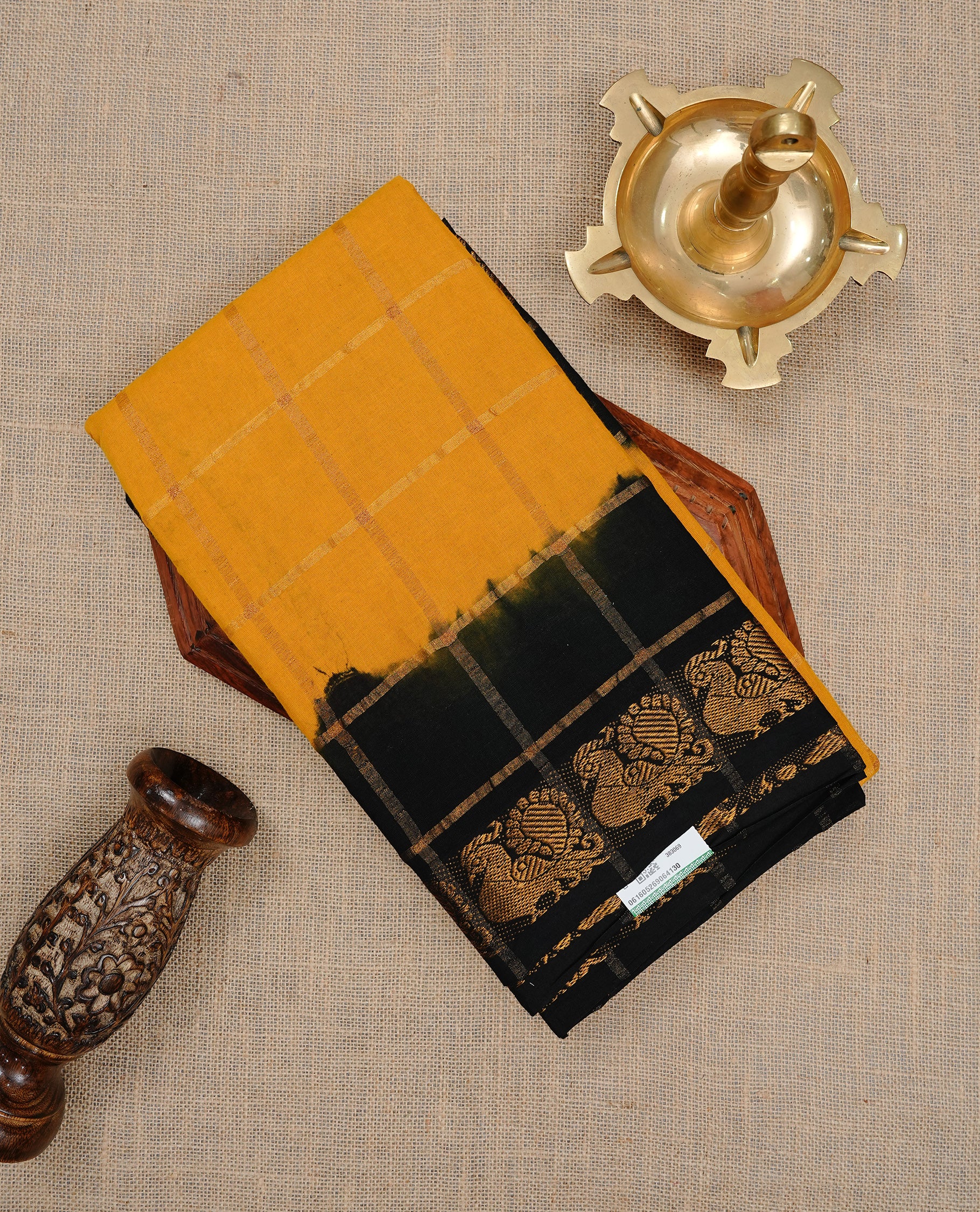 Mustard colour Sungudi cotton saree featuring Gold zari Check pattern on body, Gold zari Peacock design on Dyed Black colour design border, paired with matching blouse piece.