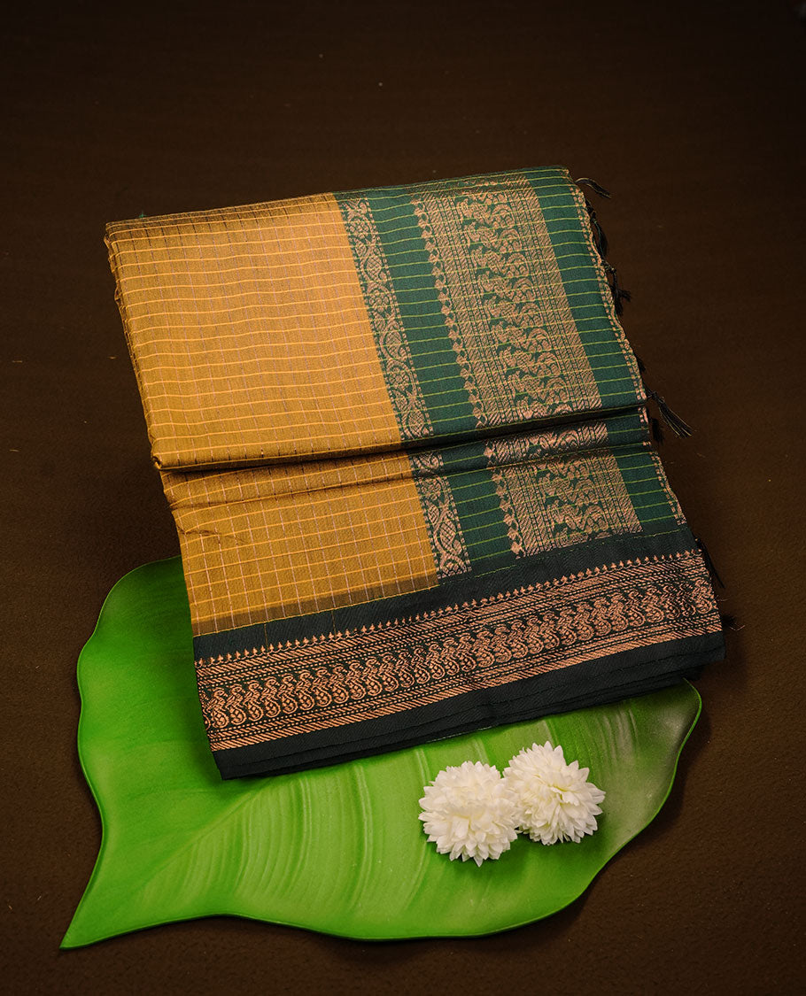 Mustard colour kalyani cotton saree featuring gold zari check pattern on body, complemented by green colour with Antique zari border, paired with matching blouse piece.
