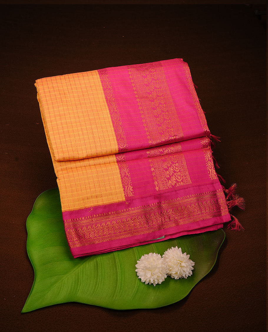 Yellow colour kalyani cotton saree featuring gold zari check pattern on body, complemented by Magenta colour with Antique zari border, paired with matching blouse piece.