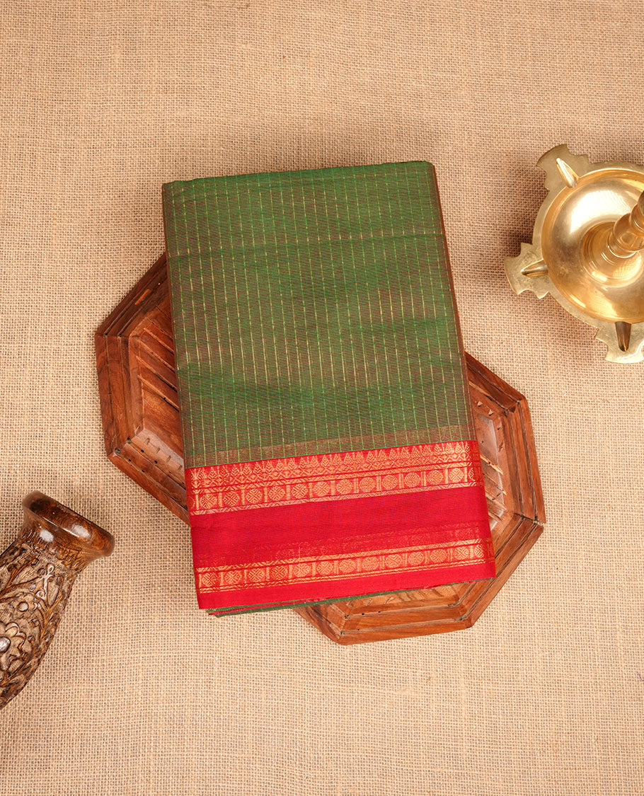 Green colour chettinad cotton featuring gold zari check pattern on body , complemented by contrast Maroon colour with gold zari border, paired with matching blouse piece.