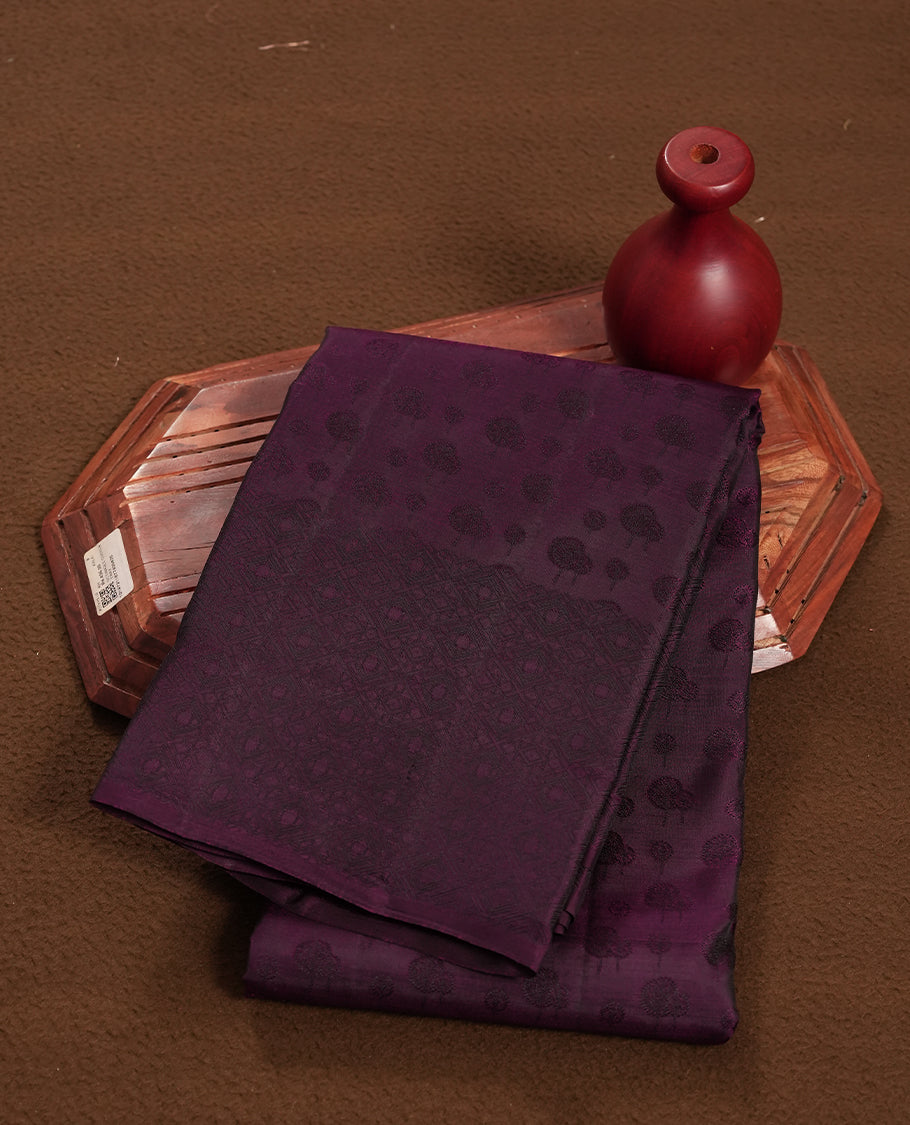 Dark wine colour semi soft silk saree featuring a self coloured textured patterned body, complemented by self coloured motifs on pallu & border and a matching blouse piece.