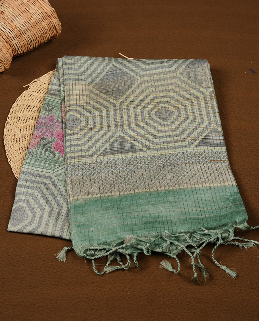 Light green colour semi tussar silk saree featuring geometric print and gold zari check pattern across body, contrast green colour border and pallu, paired with matching blouse piece.