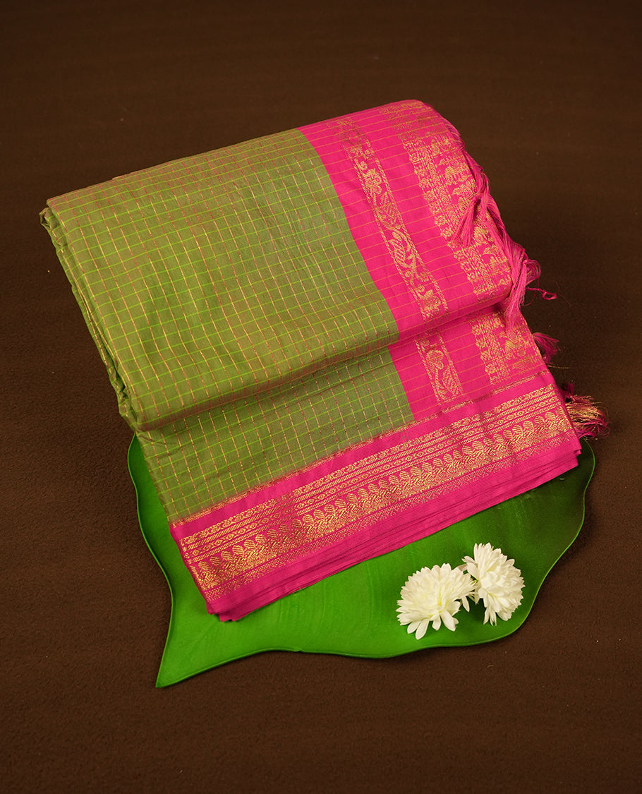 Pistachio coloured mixed Kalyani cotton saree featuring golden zari checks on the body, complemented by a pink coloured border and pallu adorned with golden zari patterns, Paired with a matching blouse.