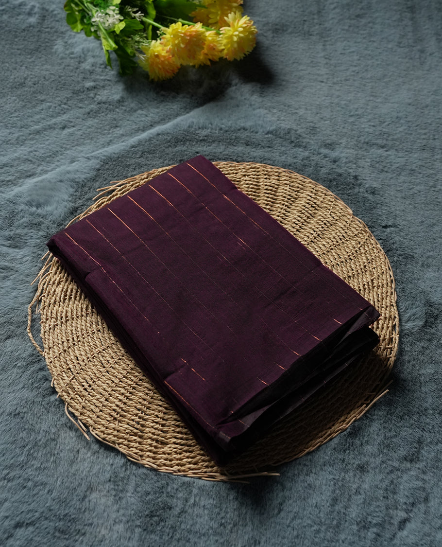 Dark maroon Colour silk cotton saree with fine antique gold pinstripes throughout the body, tawny bronze pallu with layered gold bands, plain tawny bronze blouse. Elegant color blocking perfect for festive occasions.