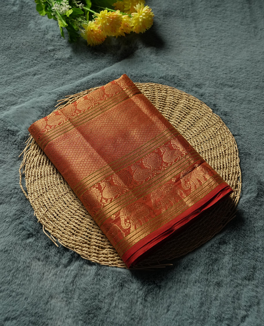 Olive Grey Colour silk cotton saree with broad temple-red zari border featuring peacocks and elephant motifs, subtle gold-striped pallu, and a plain olive grey blouse with the same rich zari border.