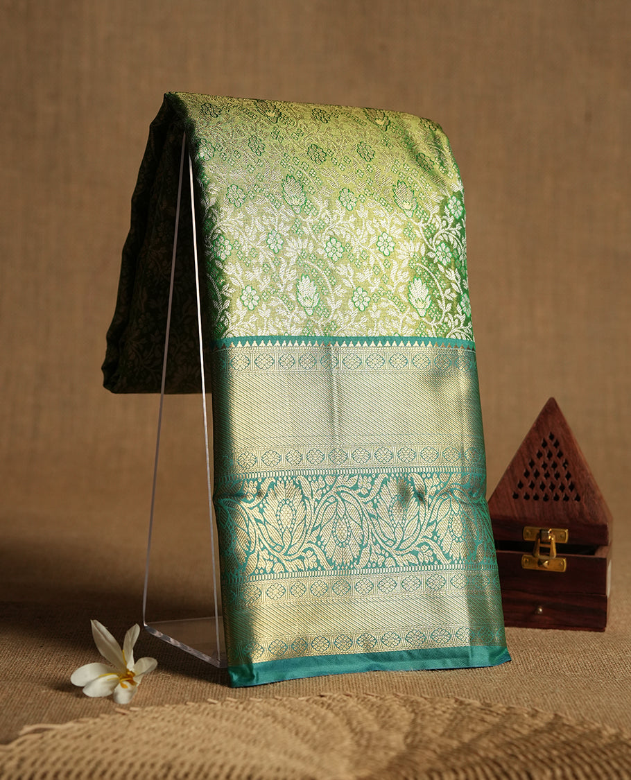 Light green colour and silver Zari Tissue Brocade Saree features intricate Dimond floral Motifs on body and dark green colour contrast with traditional border & pallu, paired with matching blouse
