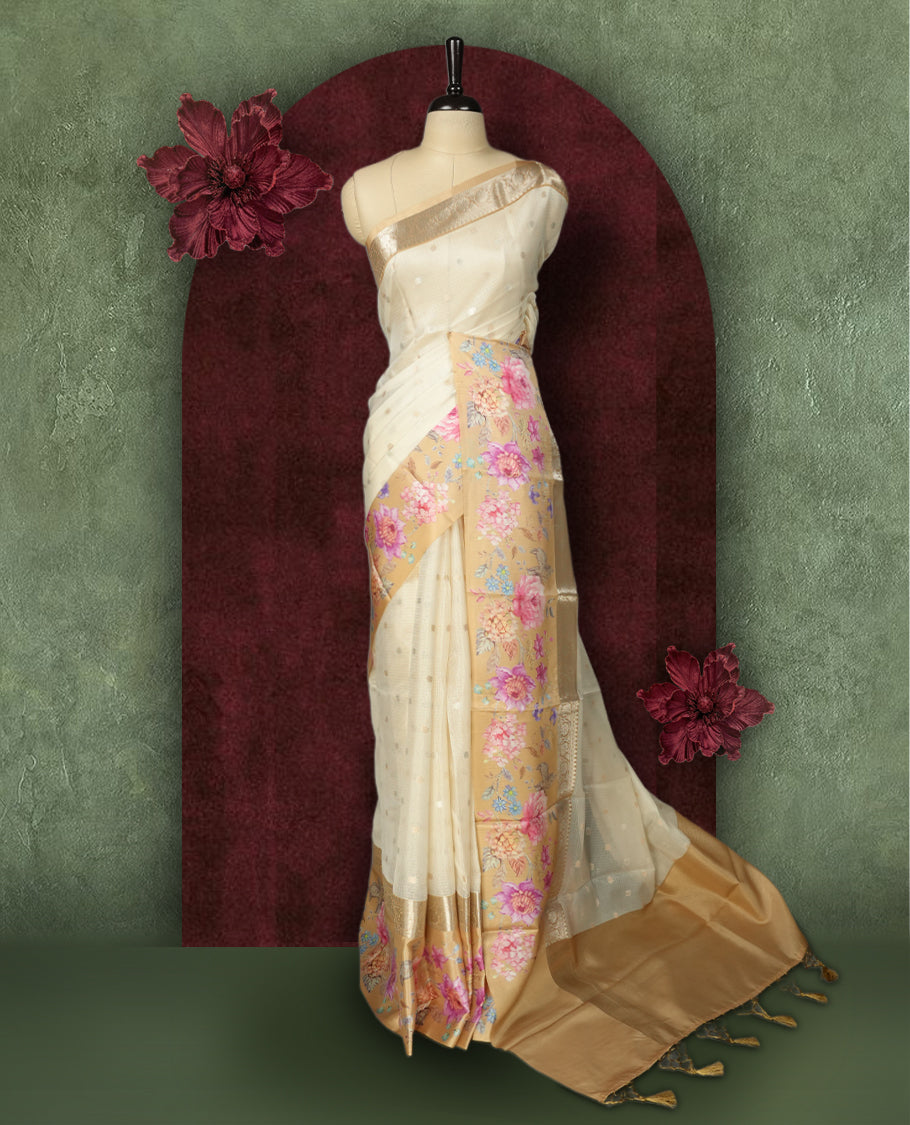 Ivory colour Kotta Tussar Silk saree features a vibrant digital floral print with small gold zari motifs on the body, and elegant banarasi border adds a regal touch & Paired with a matching blouse,blending modern design with traditional elegance.