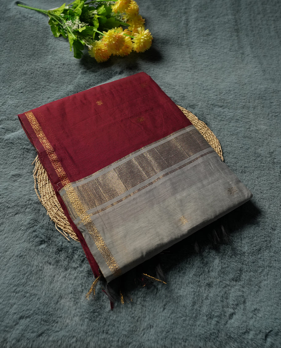 Maroon and pale gold Colour silk cotton saree with zari star buttas, antique gold tissue pallu, slim floral zari borders, and a plain pale gold blouse with matching border.