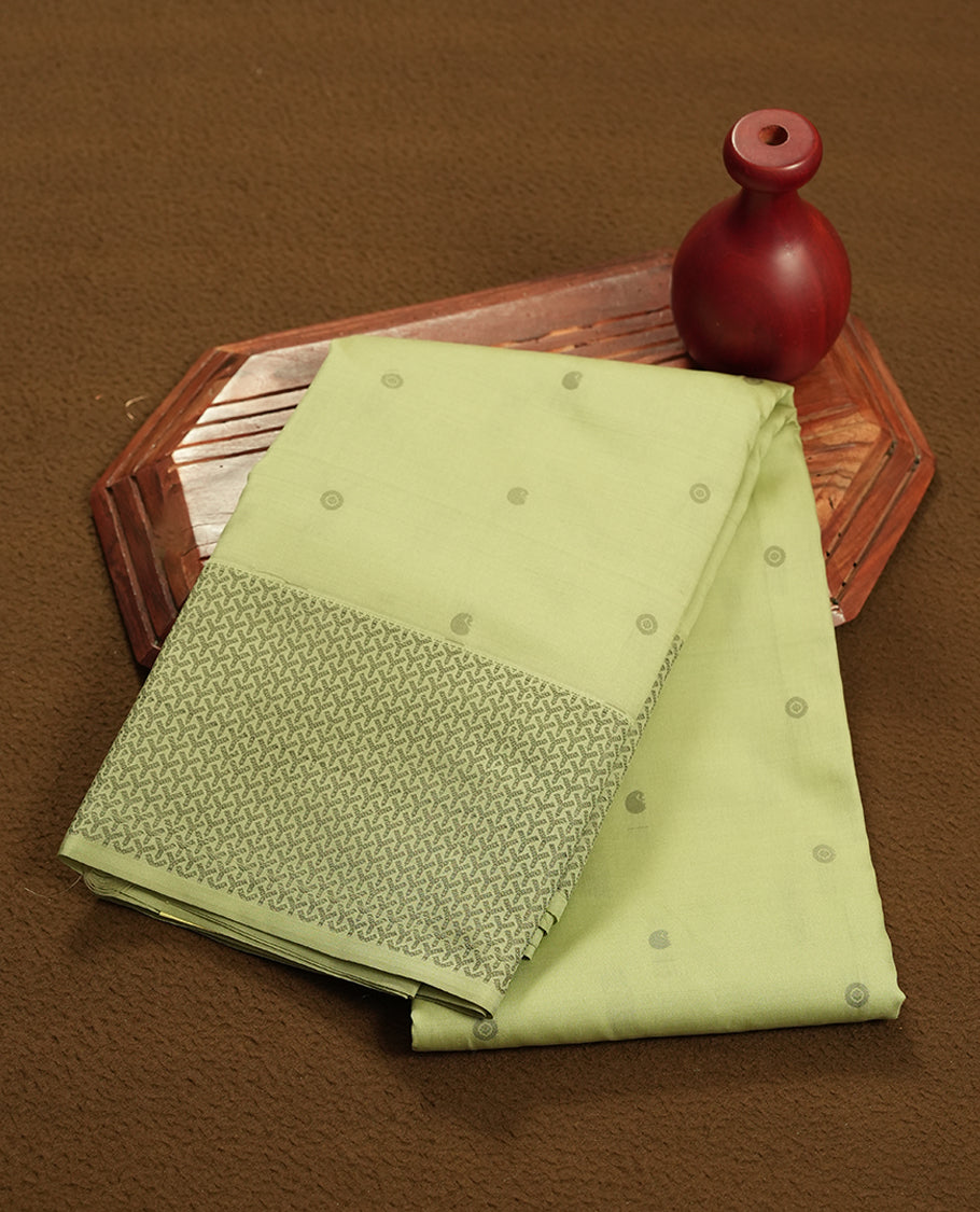 Pastel green colour semi soft silk saree featuring a gray colour textured patterned body, complemented by self coloured with gray colour motifs pallu & border and a matching blouse piece.