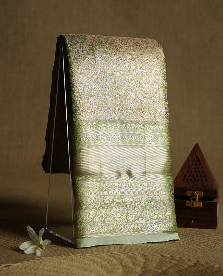 Golden green colour and rose gold Zari Tissue Brocade Saree features intricate floral Motifs on body and pastel green colour contrast border with traditional border & pallu, paired with matching blouse