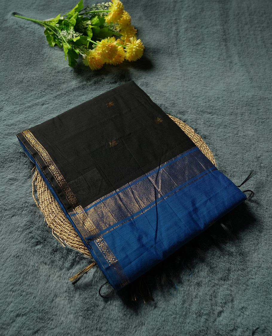 Black and Royal Blue Colour silk cotton saree with gold zari star buttas, blue pallu with zari stripes and buttas, slim antique-gold borders, and a plain blue blouse featuring matching zari edging