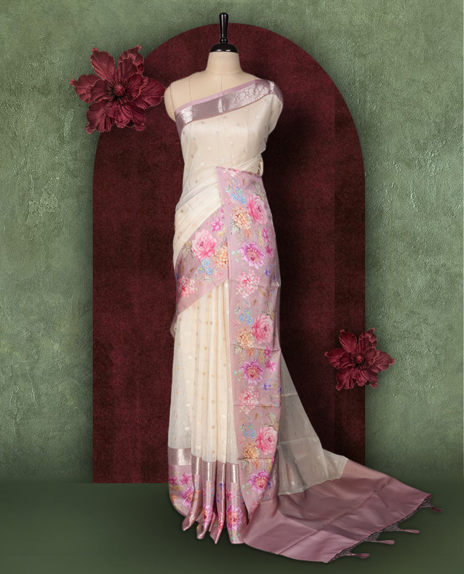 Ivory colour Kotta Tussar Silk saree features a vibrant digital floral print with small gold zari motifs on the body, and elegant pink colour banarasi border & Paired with a matching blouse,blending modern design with traditional elegance.