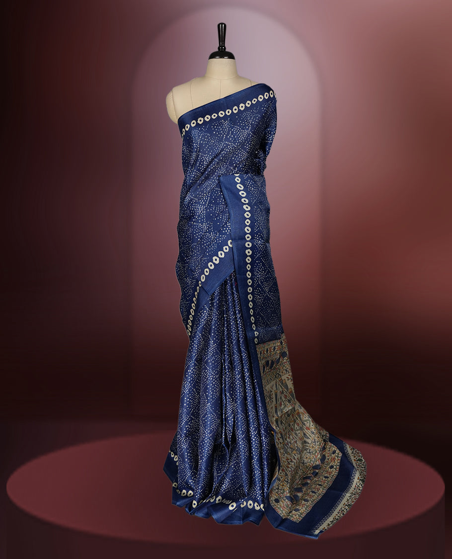 Navy blue colour saree with intricate cream dotted patterns and a striking Madhubani inspired pallu, The soft fabric offers a graceful drape, making it perfect for festive and formal occasions, paired with blouse.