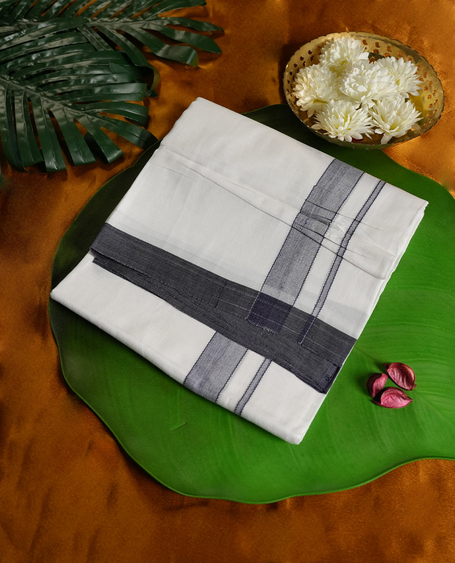 White colour cotton dhoti featuring a sleek dark navy blue border, designed with a classic weave for a refined traditional look & Perfect for festive occasions, cultural ceremonies, and temple wear.