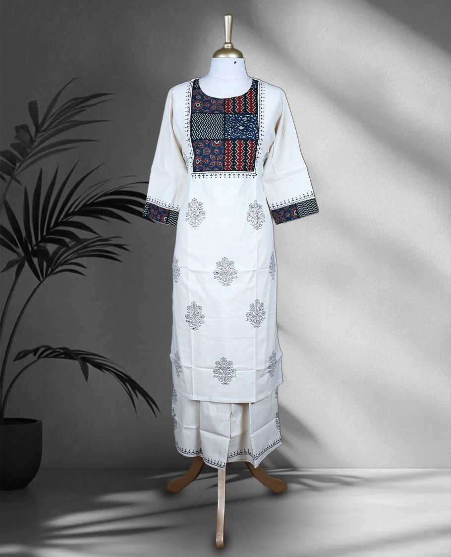 Cream colour cotton cord set with navy blue floral prints, highlighted by vibrant patchwork on the yoke and sleeve borders, Paired with matching straight pants.