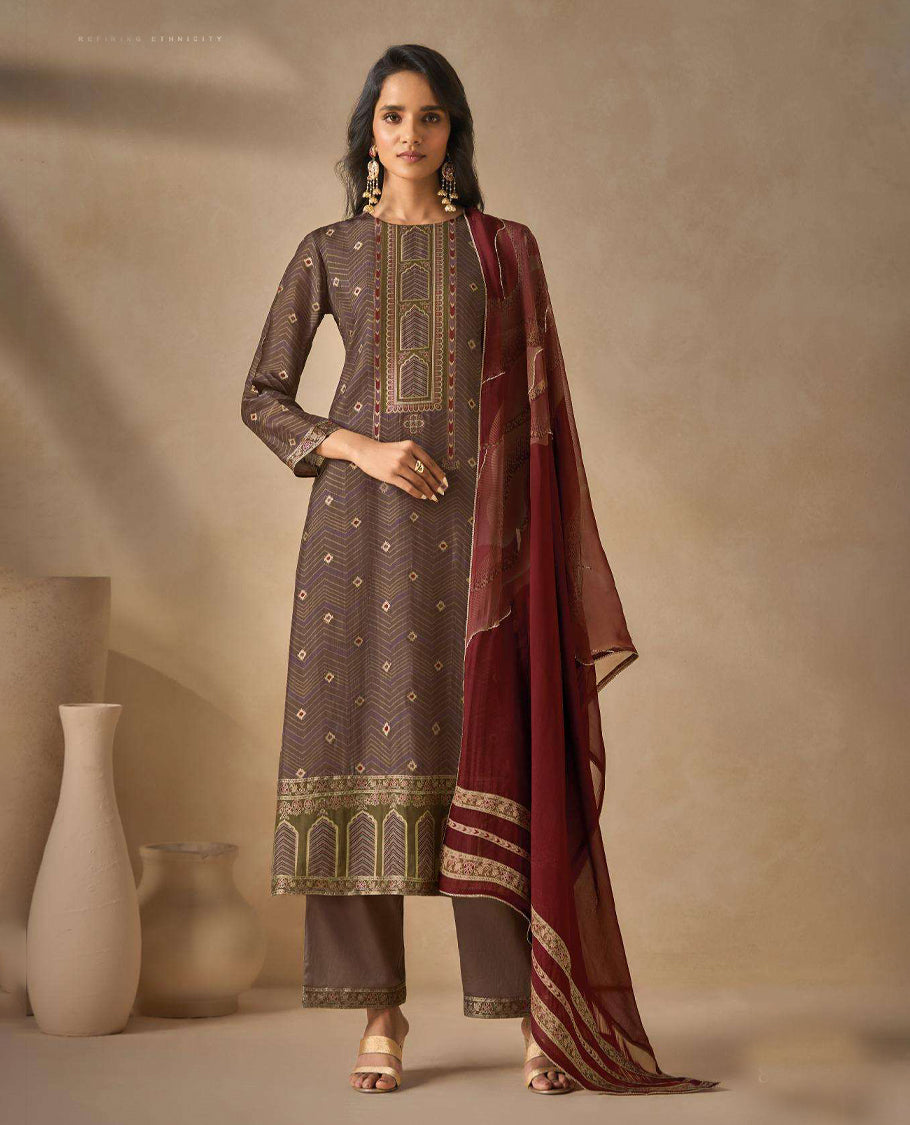 Brownish Gray colour suit material with silk jacquard digital print top with embroidery highlighted sleeve work, paired with matching satin bottom and a contrast lightweight printed dupatta.