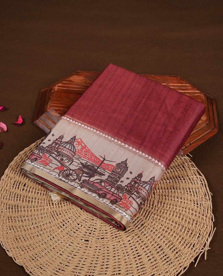 Brick red colour semi tusser silk saree featuring contrast cream colour London bridge printed pattern border and paired with matching blouse.