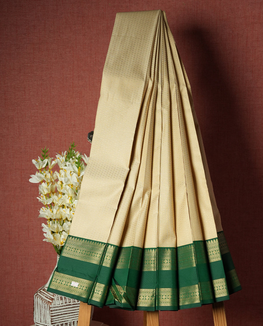 Ivory Cream Colour Semi Silk Saree with Subtle Self Textured Body, Contrasting Emerald Green Golden Zari Pallu & Border, Temple Motifs, and Matching Blouse Piece
