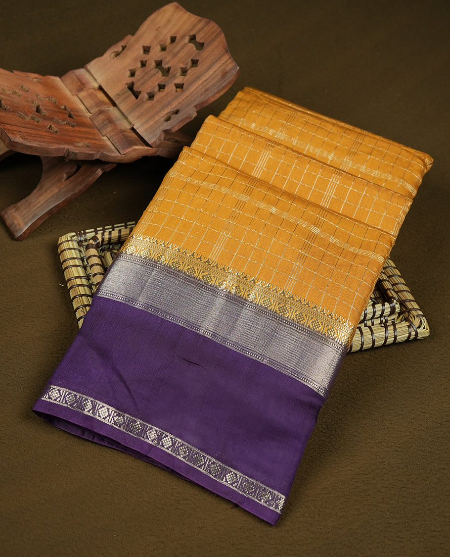 Mustard yellow colour mixed chanderi cotton saree with checkered body, deep purple pallu with rose gold zari border, and matching purple blouse.