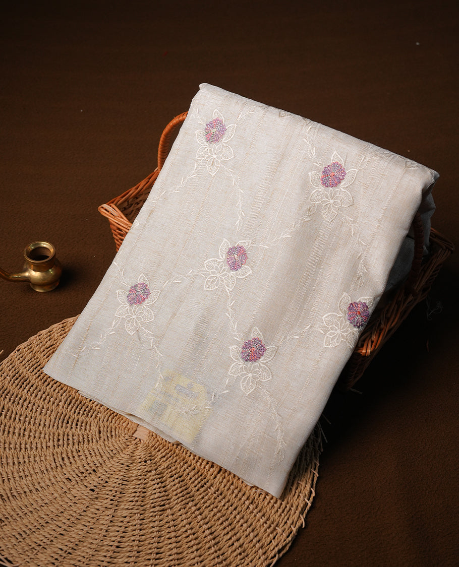 Cream colour semi tuseer silk saree featuring with Self colour thread embroidery kodi pattern & multicolour floral thread motifs all over body, pallu, and paired with matching blouse piece.