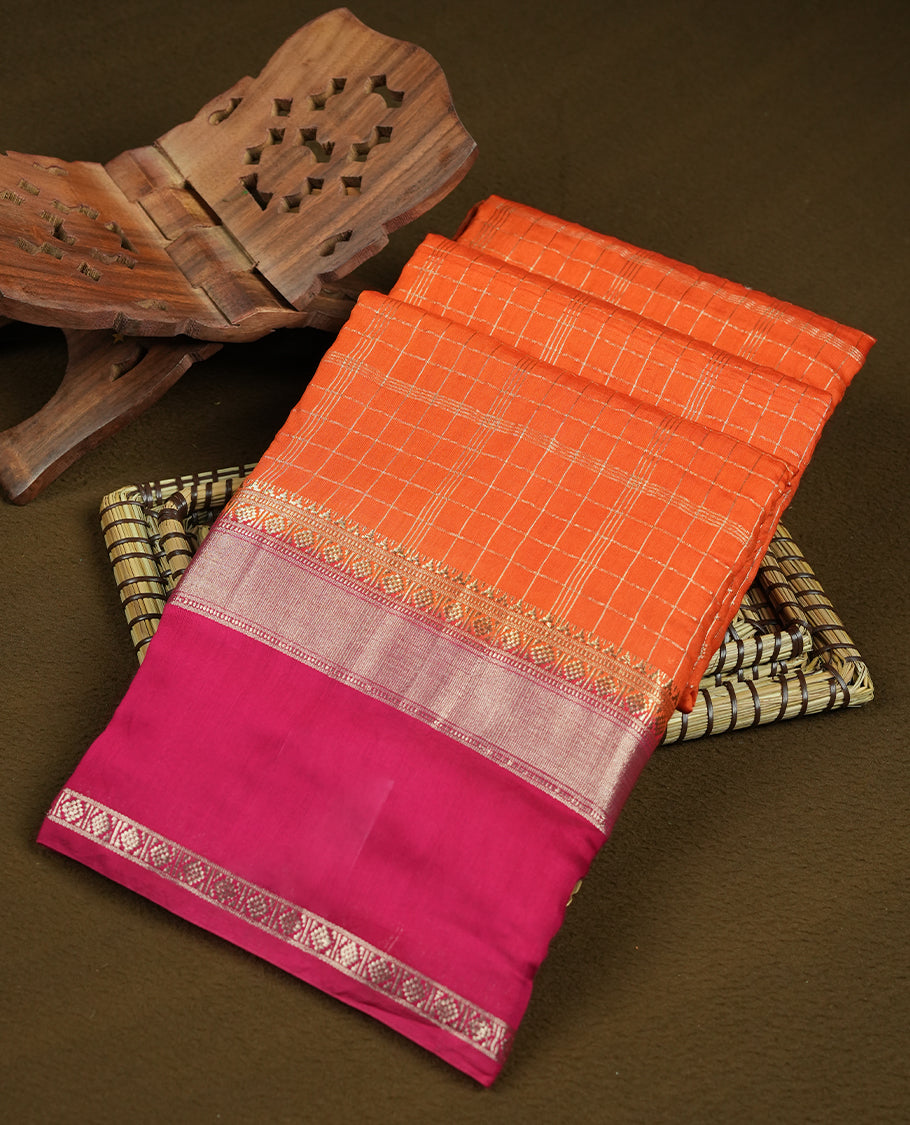 Coral orange colour mixed chanderi cotton saree with zari checkered body, rosegold zari border, magenta-pink pallu with zari checks, and matching magenta blouse.