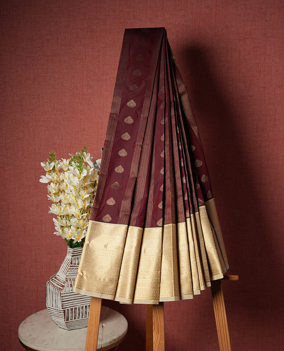 Dark brown colour Semi Silk Saree with gold zari patterns on the body, paired with a contrasting cream colour traditional pallu and border, and a matching blouse piece.