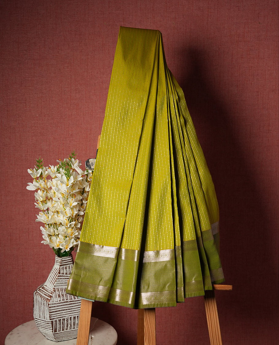 Lemon green Colour Semi Silk Saree with gold zari stripes on the body, paired with a contrasting olive colour pallu and border, and a matching blouse piece.