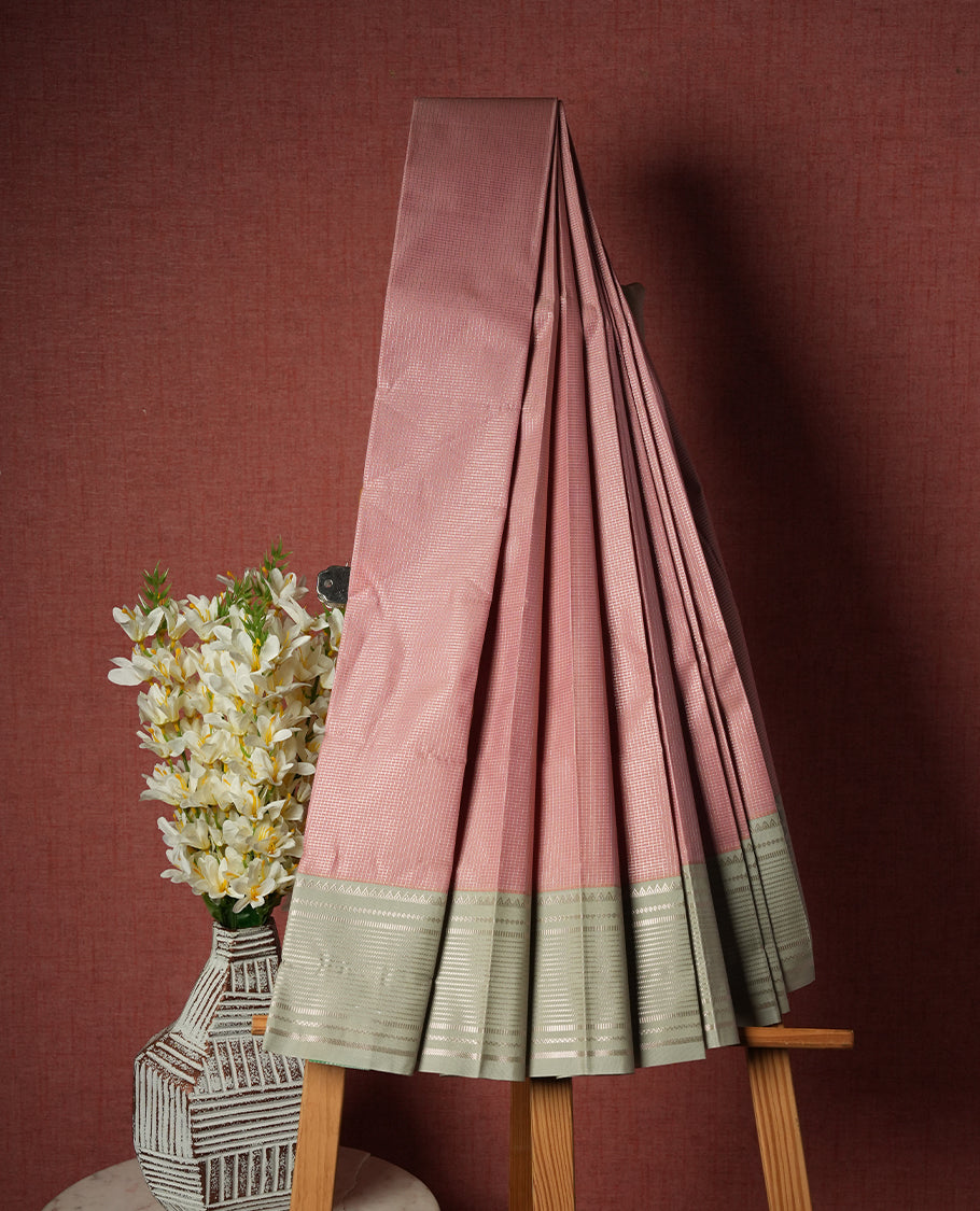 Pastel pink colour Semi Silk Saree with gold zari striped patterns on the body, paired with a contrasting Gray colour traditional pallu and border, and a matching blouse piece.