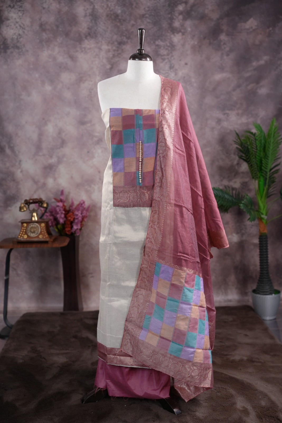 Onion pink colour tissue Madras check salwar material featuring a plain body with a classic Kasavu border, paired with a Chanderi dupatta adorned with a matching Kasavu border and a Shantoon fabric bottom.