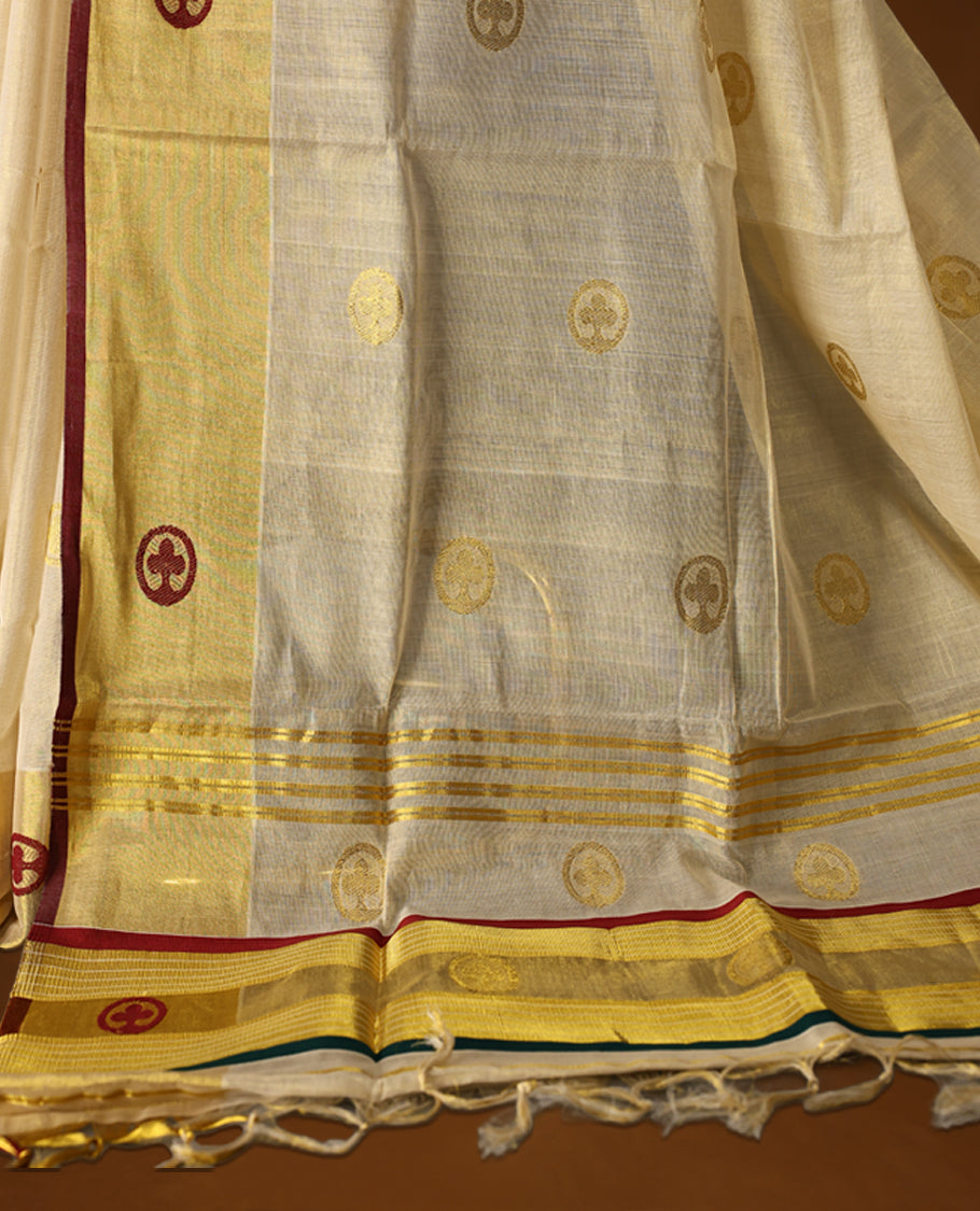 Elegant handloom soft tissue kerala saree. Featuring a cream base with gold zari, maroon , green borders & woven motifs, and paired with a matching blouse, perfect for festivities