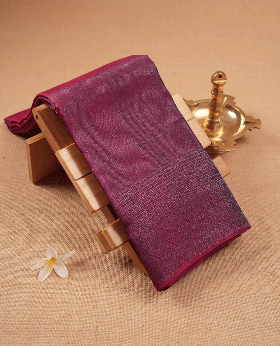Maroon coloured Manthrakodi saree featuring a multicoloured zari jacquard body, complemented by a self coloured turning Banarasi border and a matching self coloured blouse.