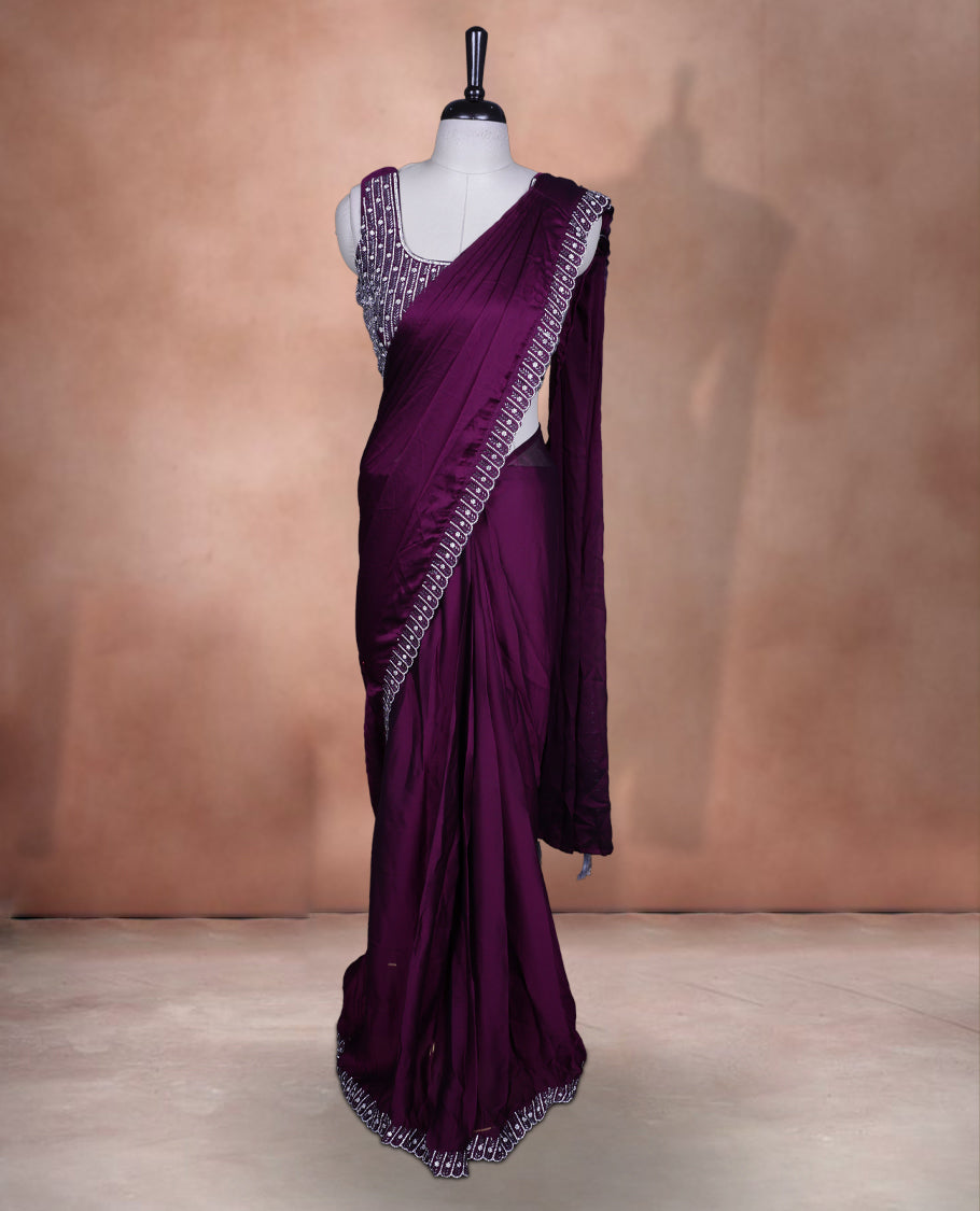 Elegant Grape colour ready to wear saree adorned with rich white stone and bead embroidery along the border and pallu, paired with a heavily embellished matching blouse for a grand festive look.