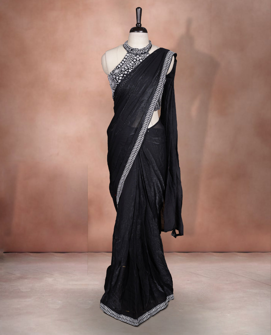 Elegant Black colour ready to wear saree adorned with rich silver stone embroidery along the border and pallu, paired with a heavily embellished matching blouse for a grand festive look.