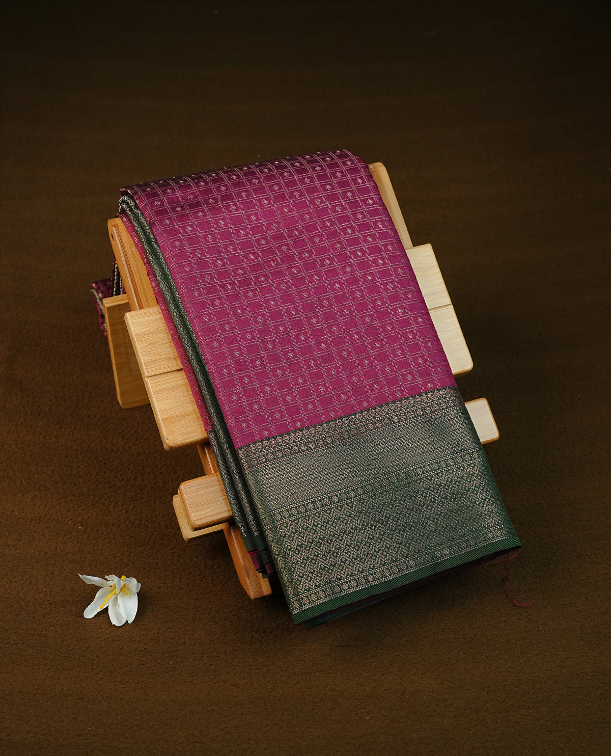 Wine colour semi silk saree featuring gold zari check patterns with buttas on body, contrast green colour with traditional border on body, grand pallu comes with matching blouse piece