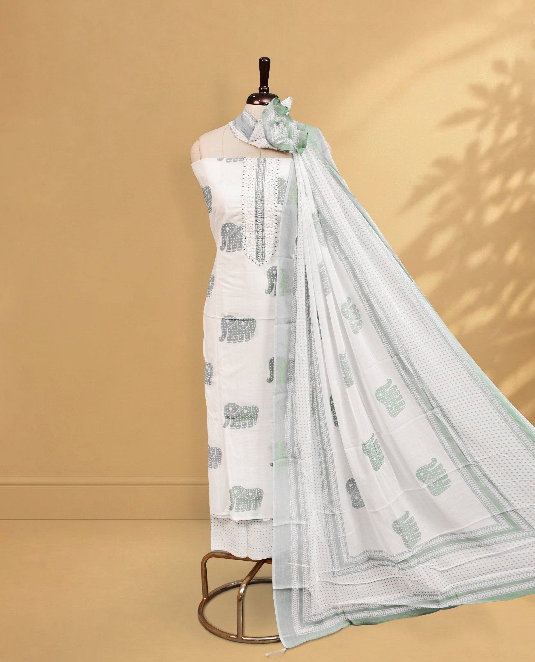 Off White colour salwar material Featuring Green Colour motifs & beats on body, paired with matching bottom & Elegant Dupatta